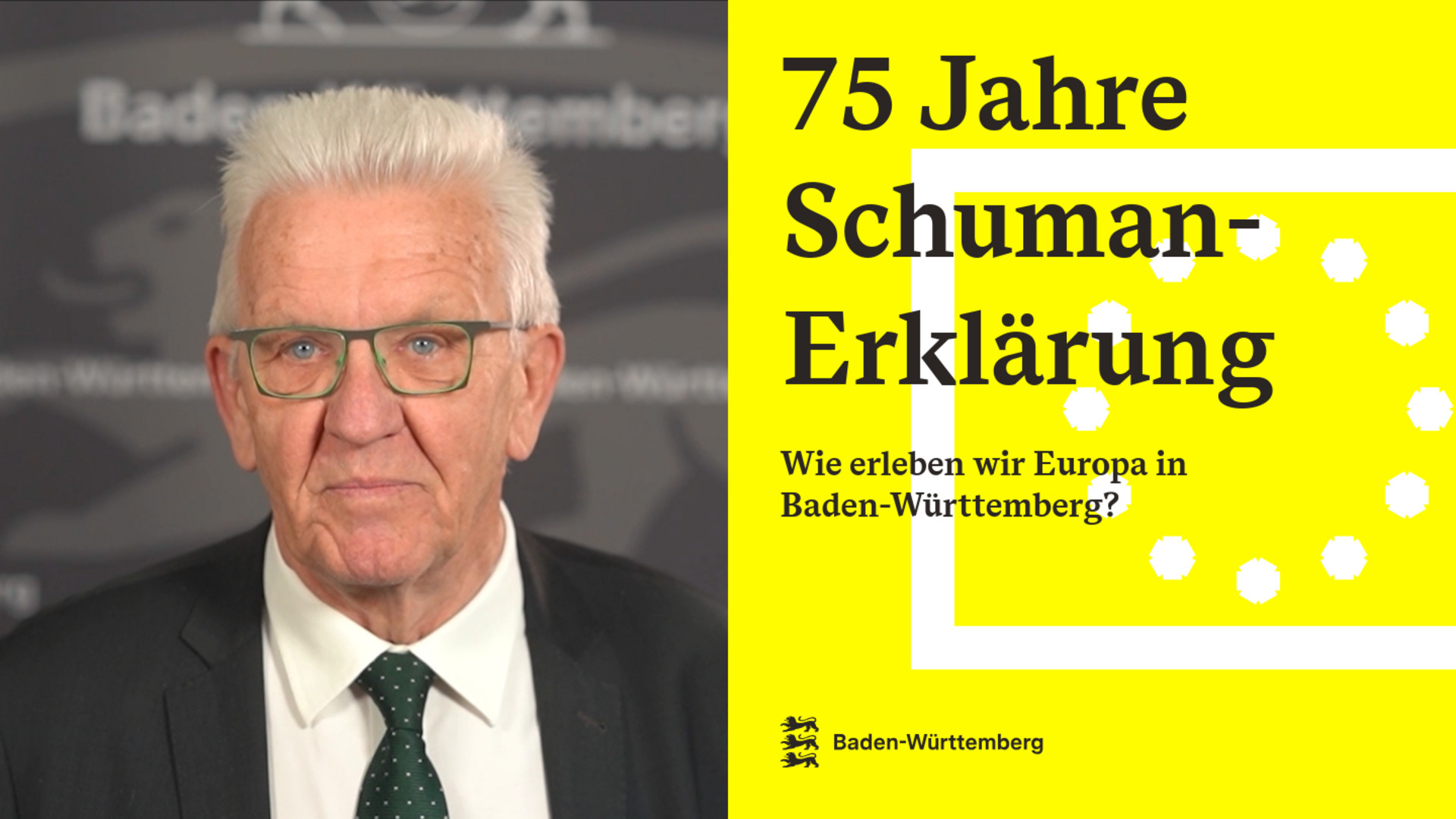 Ministerpräsident Winfried Kretschmann vor einer grauen Pressewand mit Baden-Württemberg-Schriftzug, daneben auf gelbem Hintergrund Text zu 75 Jahre Schuman-Erklärung