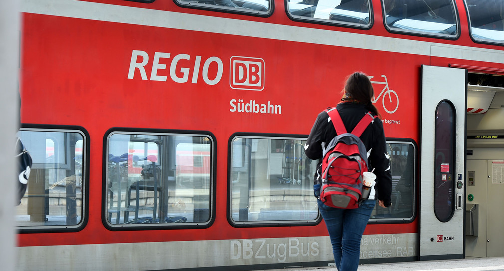 Ein Personenzug „Regio DB Südbahn“ steht in einem Bahnhof (Foto: © dpa)