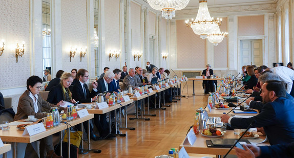 Das Kabinett sitzt im Neuen Schloss in einem Saal. 