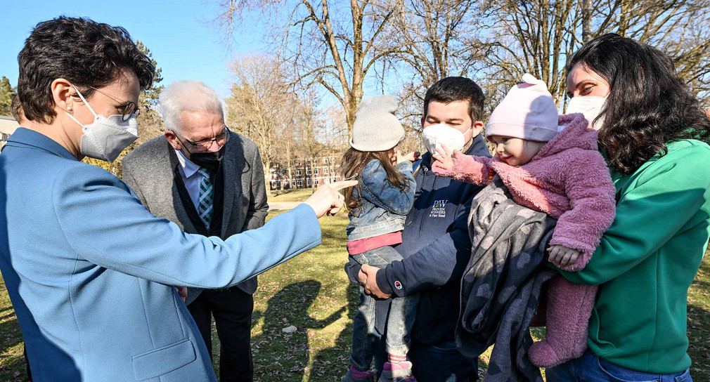 Ministerpräsident Winfried Kretschmann (zweiter von links) und Ministerin der Justiz und für Migration Marion Gentges (links) sprechen beim Besuch der Landeserstaufnahmestelle in Sigmaringen mit einer Familie, die aus der ukrainischen Hauptstadt Kiew geflohen ist.